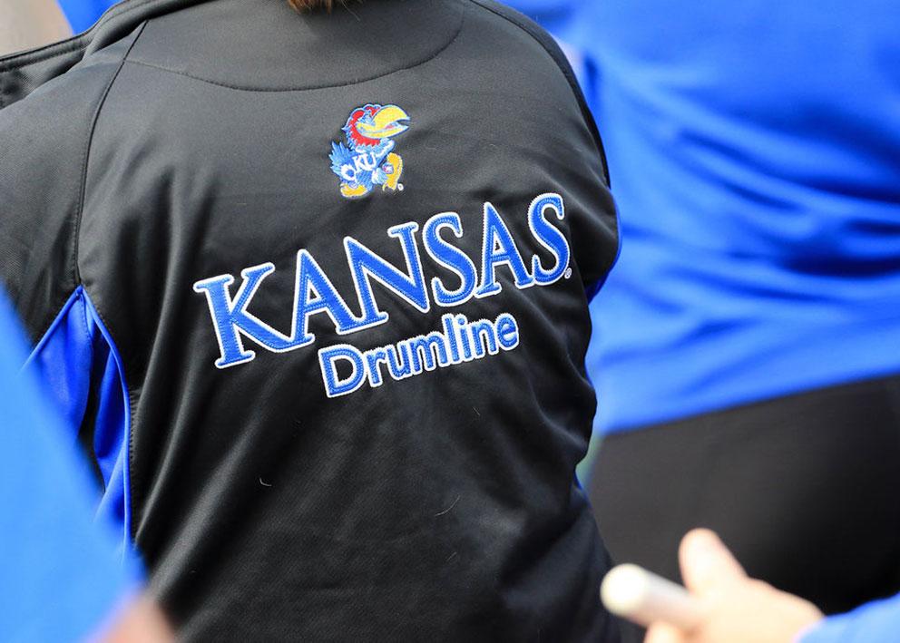 A person's back wearing a Kansas Drumline shirt