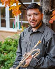 Oscar Haro holding a trumpet